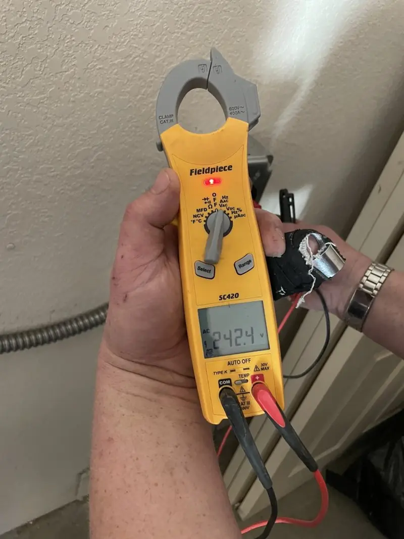 Voltage testing with clamp meter during Recessed Lighting Installation in Keowee Key